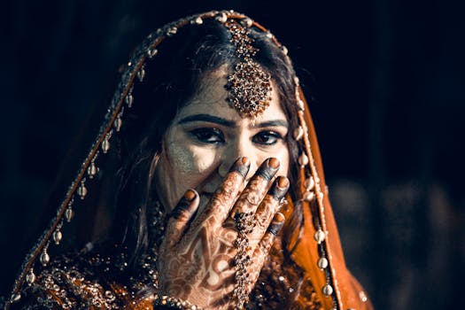 Beautiful Indian bride adorned with traditional jewelry and intricate henna designs at her wedding.