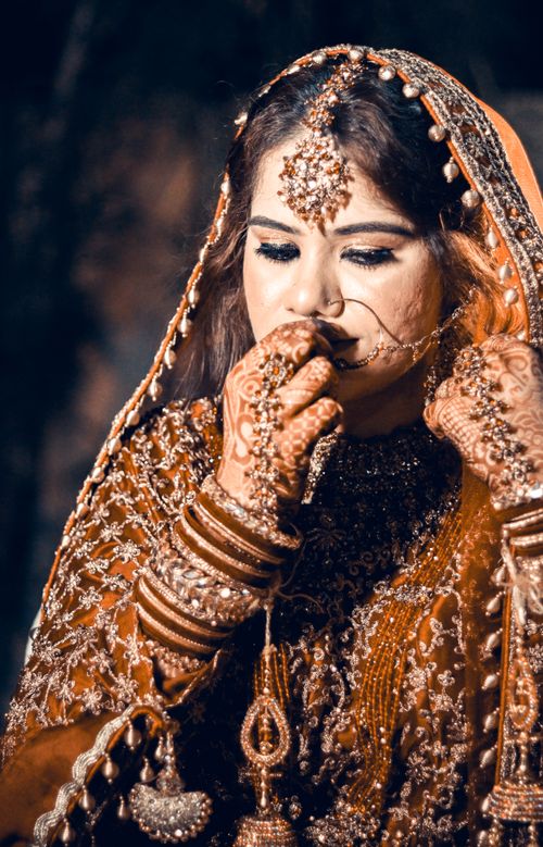 Free A captivating bridal portrait featuring a South Asian bride in traditional ornate attire, showcasing cultural richness and beauty. Stock Photo