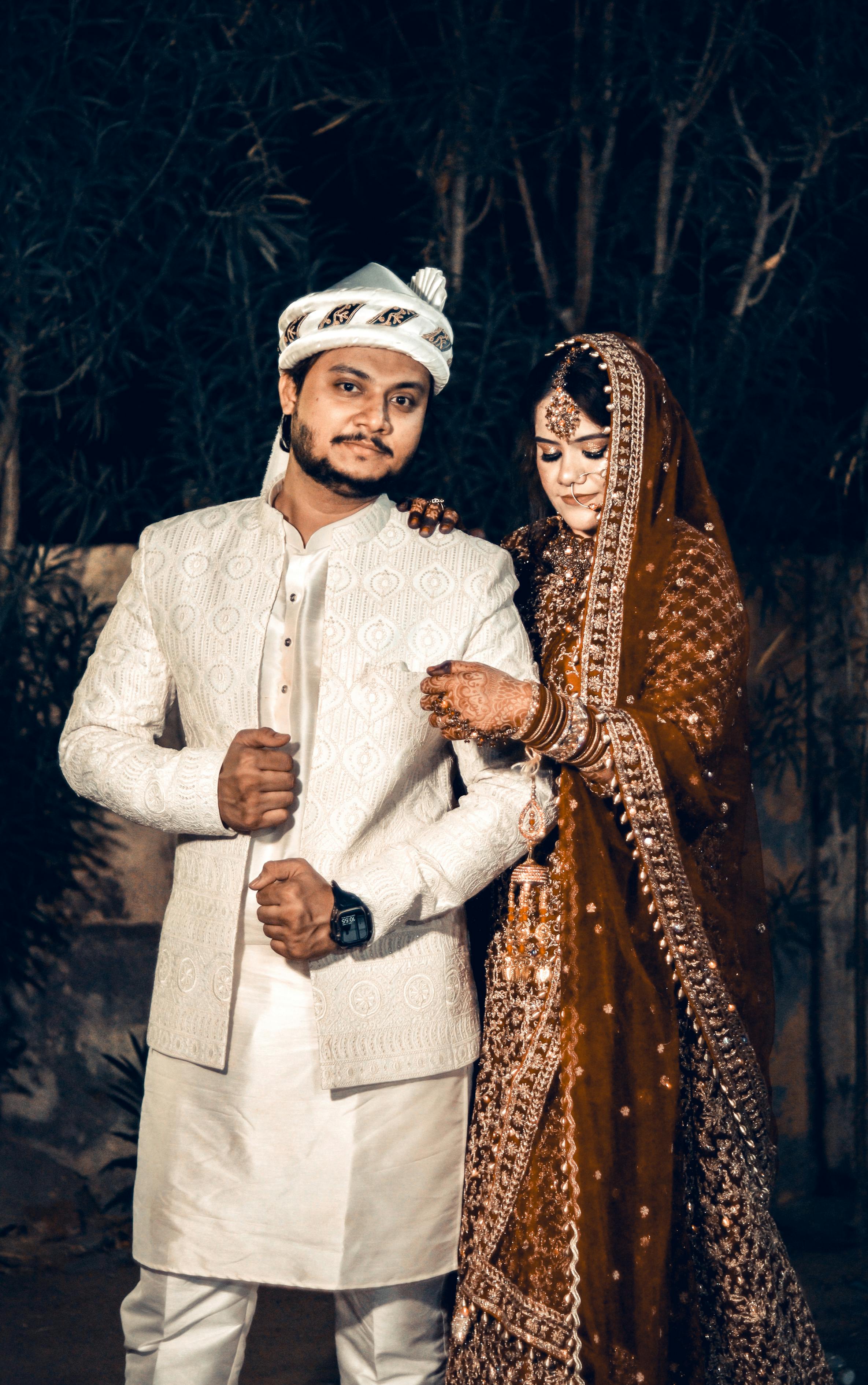 Beautiful portrait of a South Asian couple at their wedding in traditional attire.