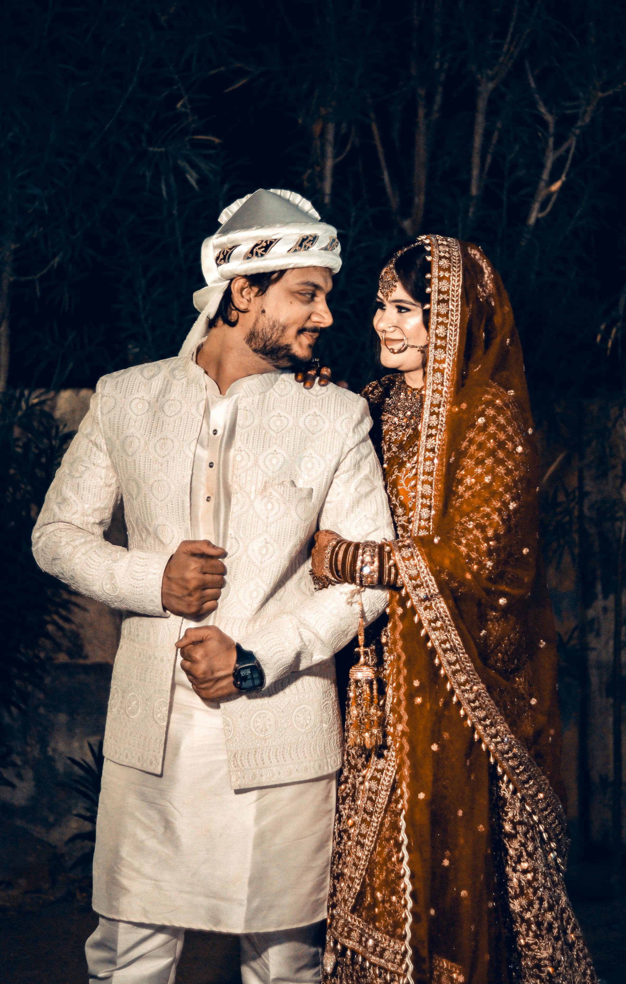 Beautiful South Asian couple in traditional attire during their wedding ceremony in Ahmedabad.
