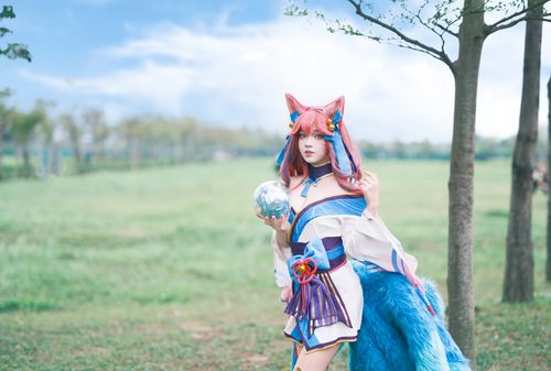 Free A vibrant cosplayer in a colorful fantasy outfit poses in a lush outdoor setting. Stock Photo
