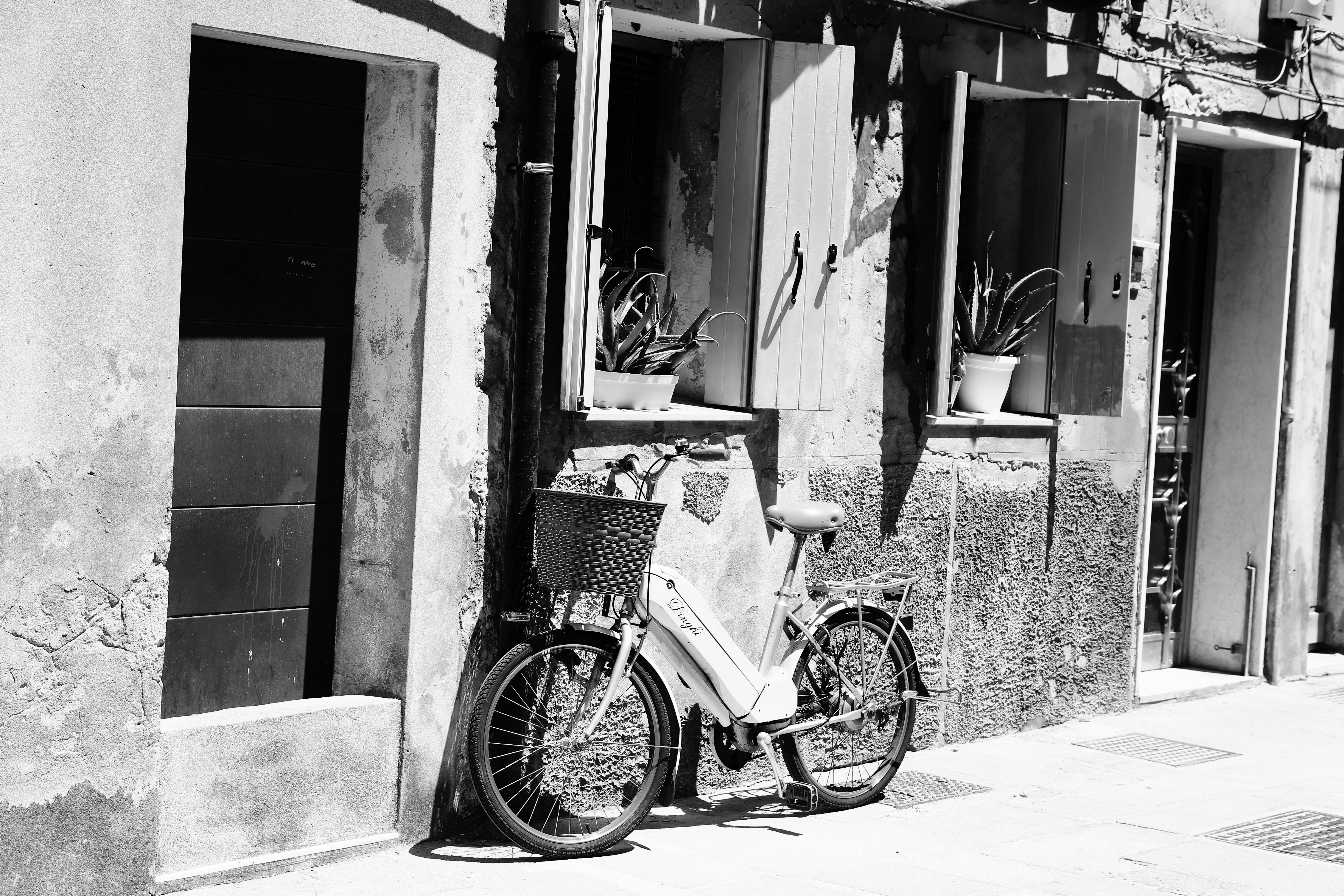 Charming urban street with an e-bike and open windows in monochrome