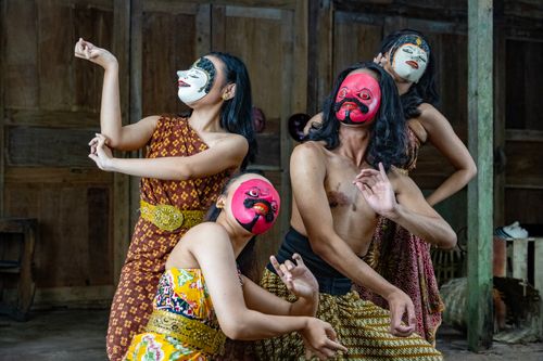 Free Cultural dance with intricate masks showcasing traditional attire in a wooden interior setting. Stock Photo