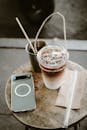Refreshing Iced Coffee and Smartphone on Café Table