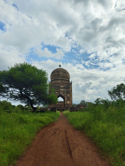 Free Majestic tomb amidst lush greenery in Bidar, KA, India. Scenic path leading through historic landscape. Stock Photo