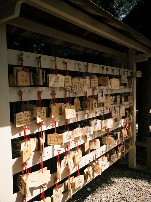 Free Rows of wooden ema plaques with wishes hang in a Japanese shrine outdoors. Stock Photo