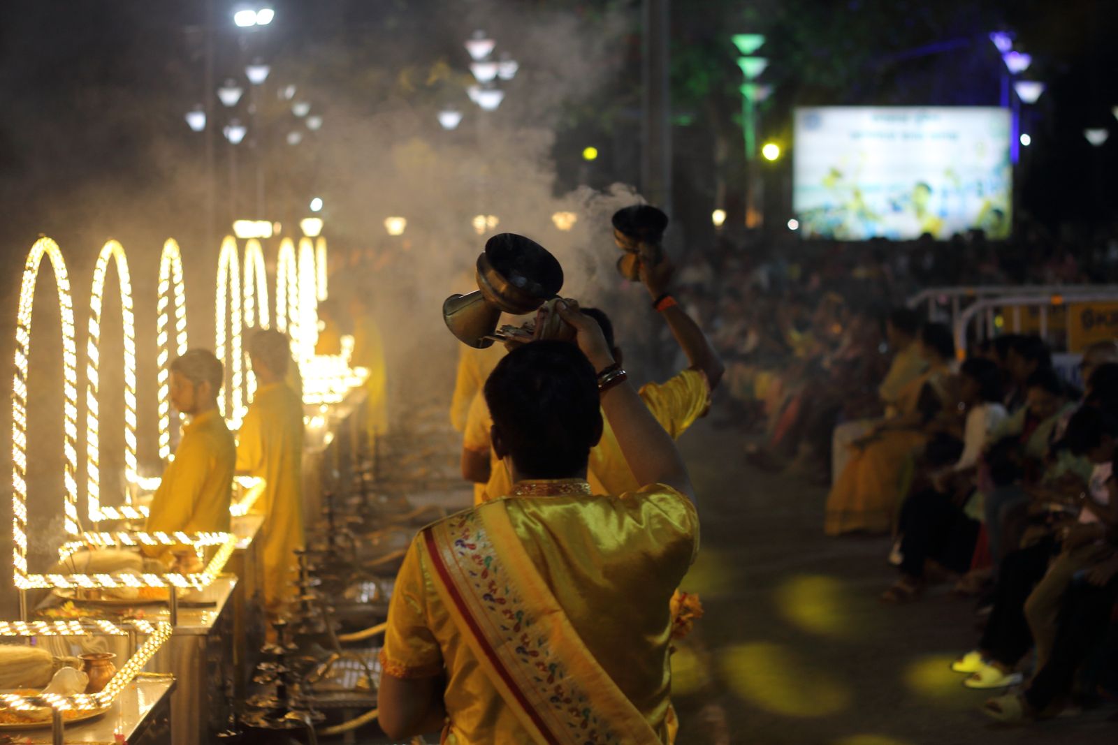 A captivating Hindu ritual along the Ganges River, showcasing traditional attire and spiritual devotion in India.