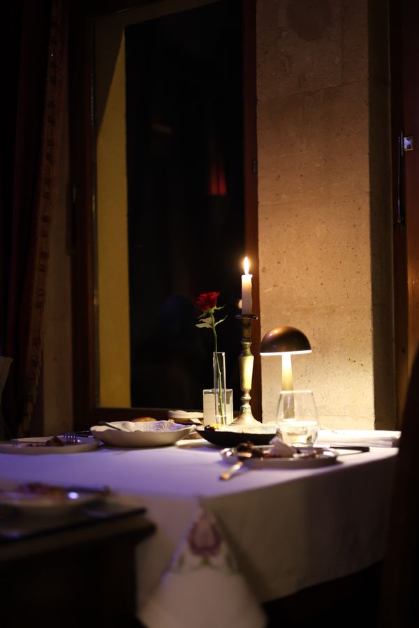 Candlelit dining table set with a single rose — Ayşenur Tekinel on Pexels