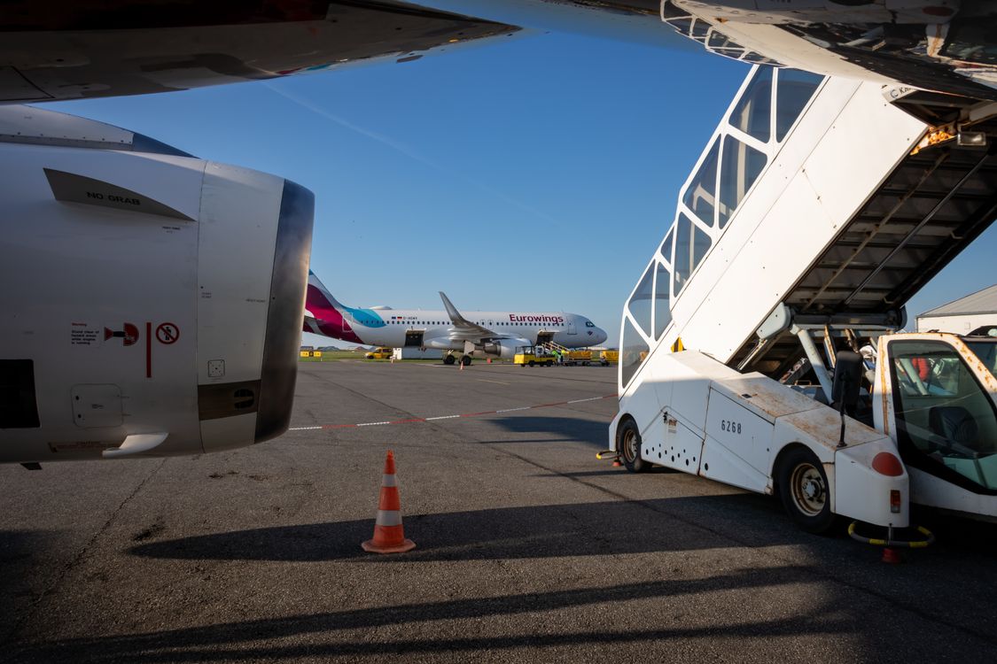 Airport tarmac with boarding stairs and aircraft ready for departure