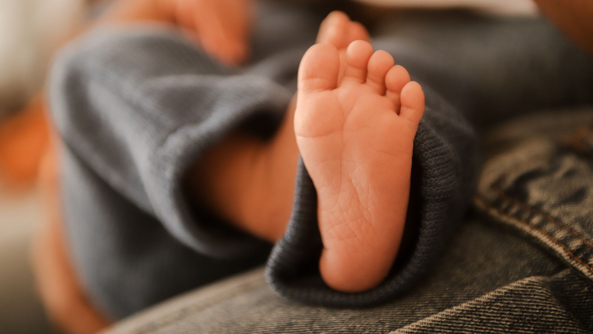 Modafinil for New Parents: Unlocking Energy and Focus A close-up of a newborn baby's foot, softly focused with a warm and cozy atmosphere — modafinil for new parents