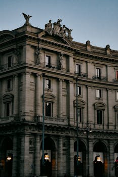 A classic Roman building in Rome, showcasing ornate ancient architecture under a twilight sky.