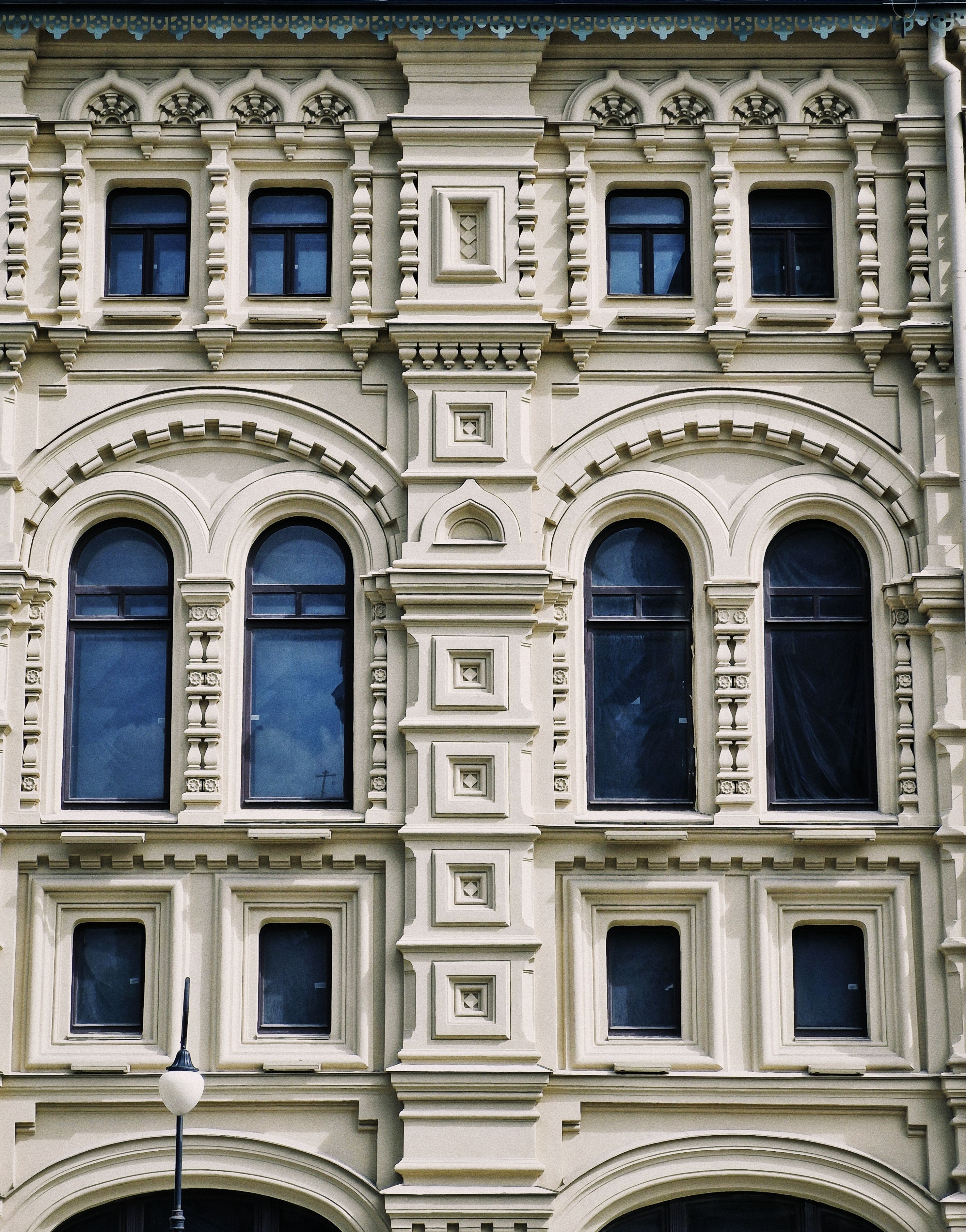 Ornate Classical Building Facade with Arched Windows · Free Stock Photo
