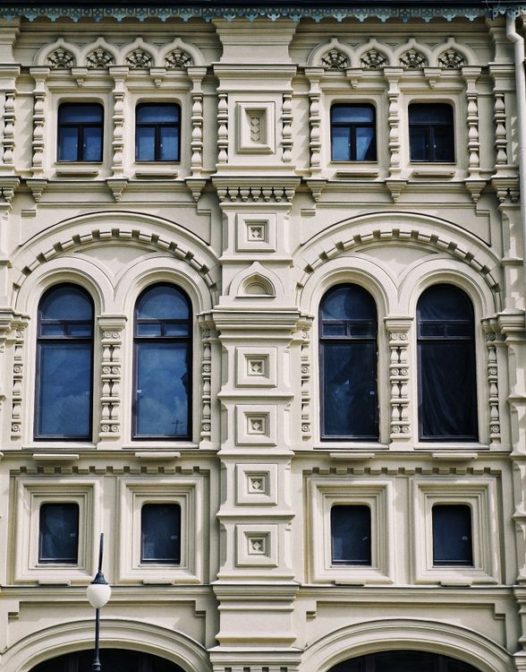 Ornate Classical Building Facade with Arched Windows · Free Stock Photo