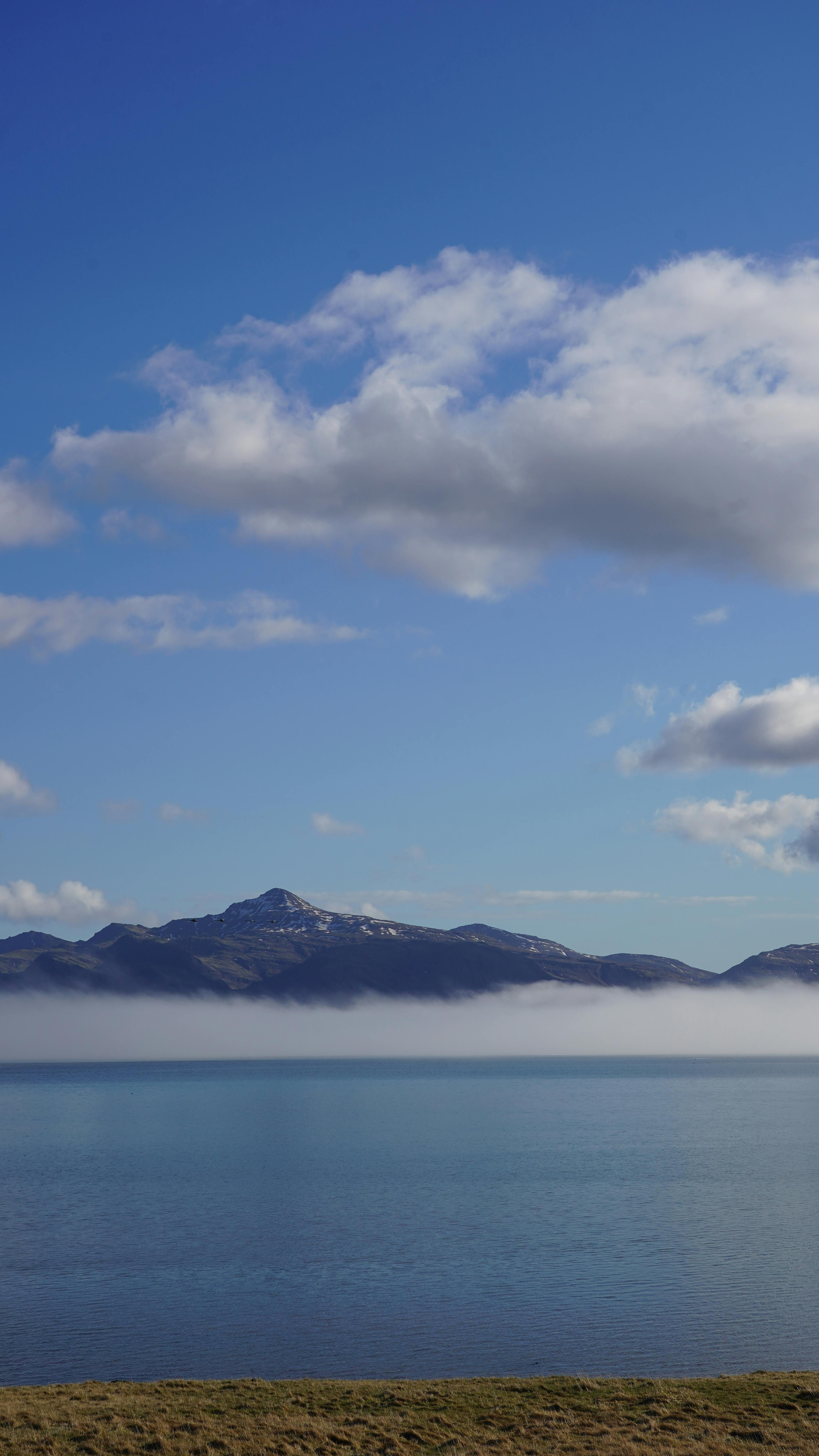 Beautiful lake with mountains and clouds in Iceland, perfect tranquil landscape.