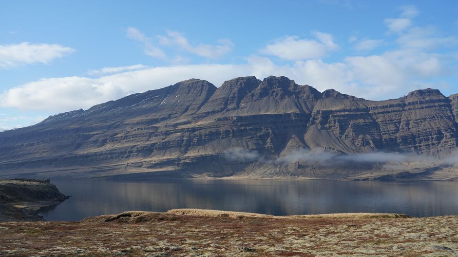 Stunning view of Icelandic mountain with clear blue sky and serene lake
