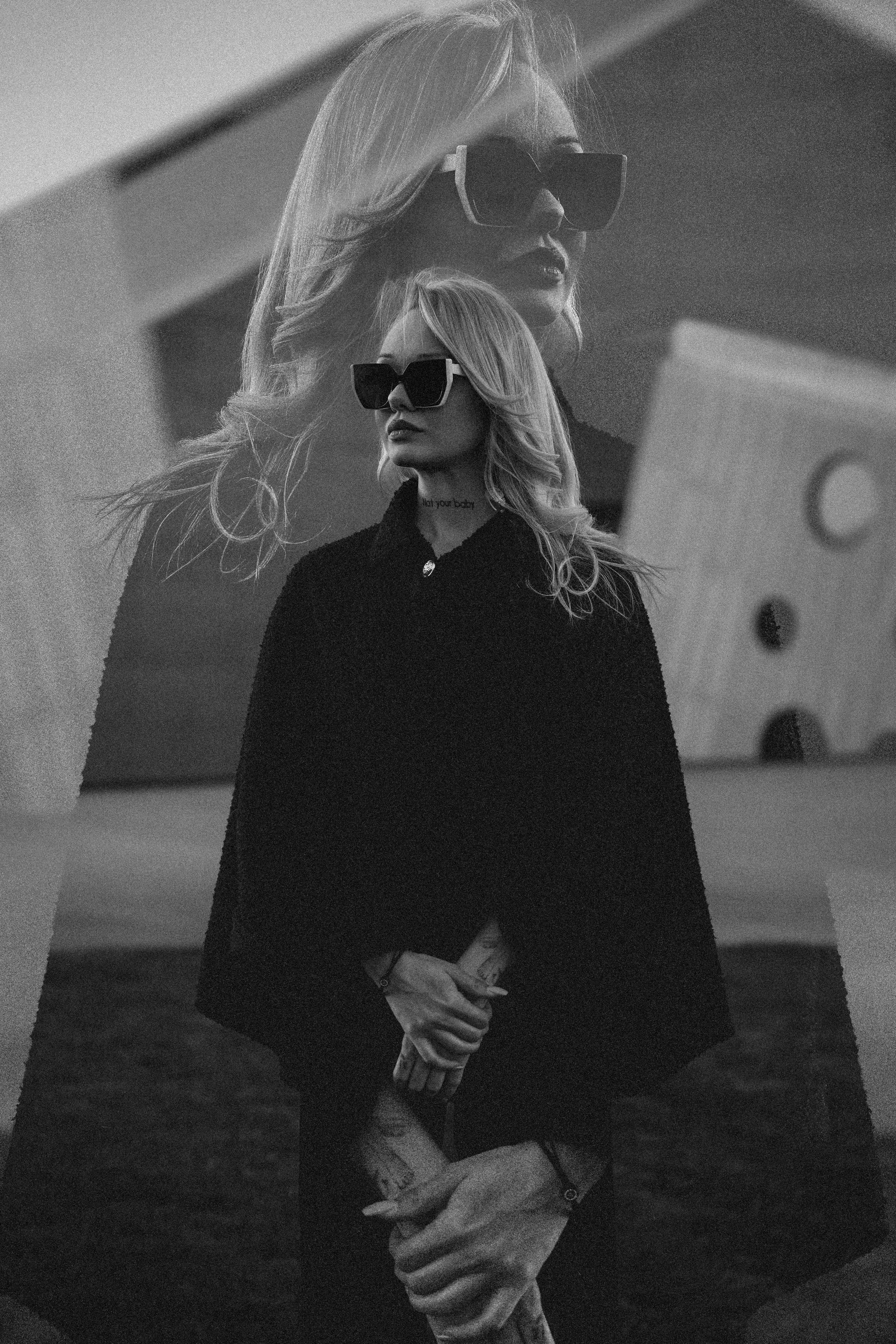 Artistic double exposure of a woman in sunglasses, blending modern portrait style.