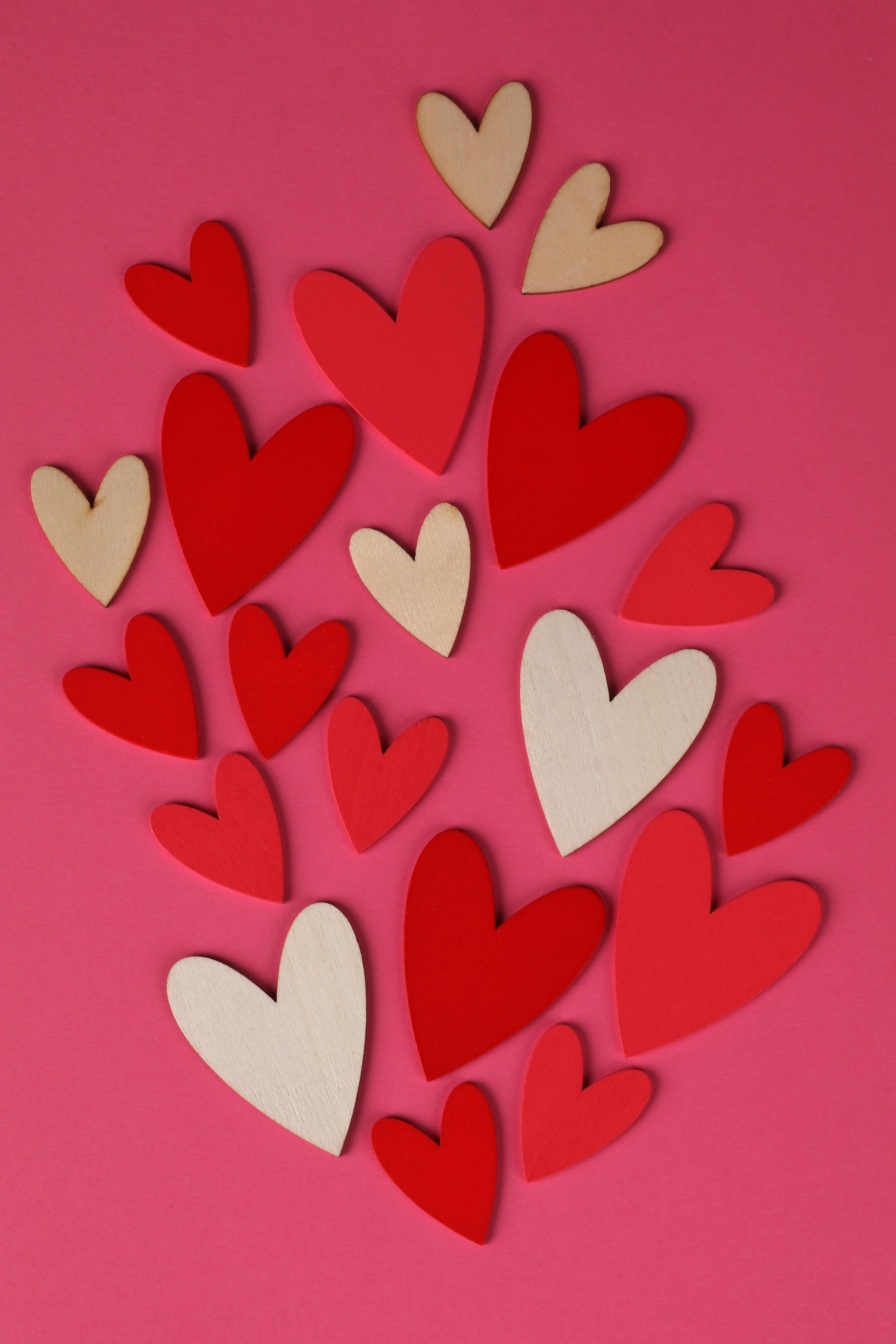 Small hearts with love word placed on surface · Free Stock Photo