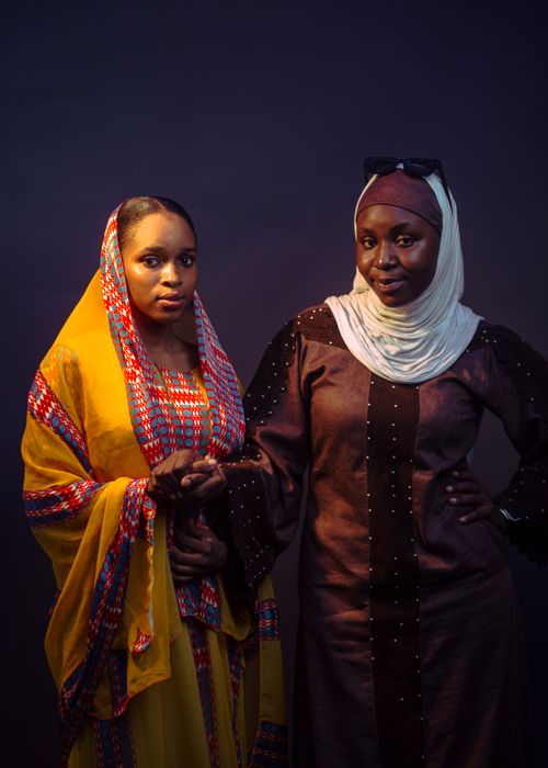 Free Two women wearing traditional colorful and elegant attire, posing confidently. Stock Photo