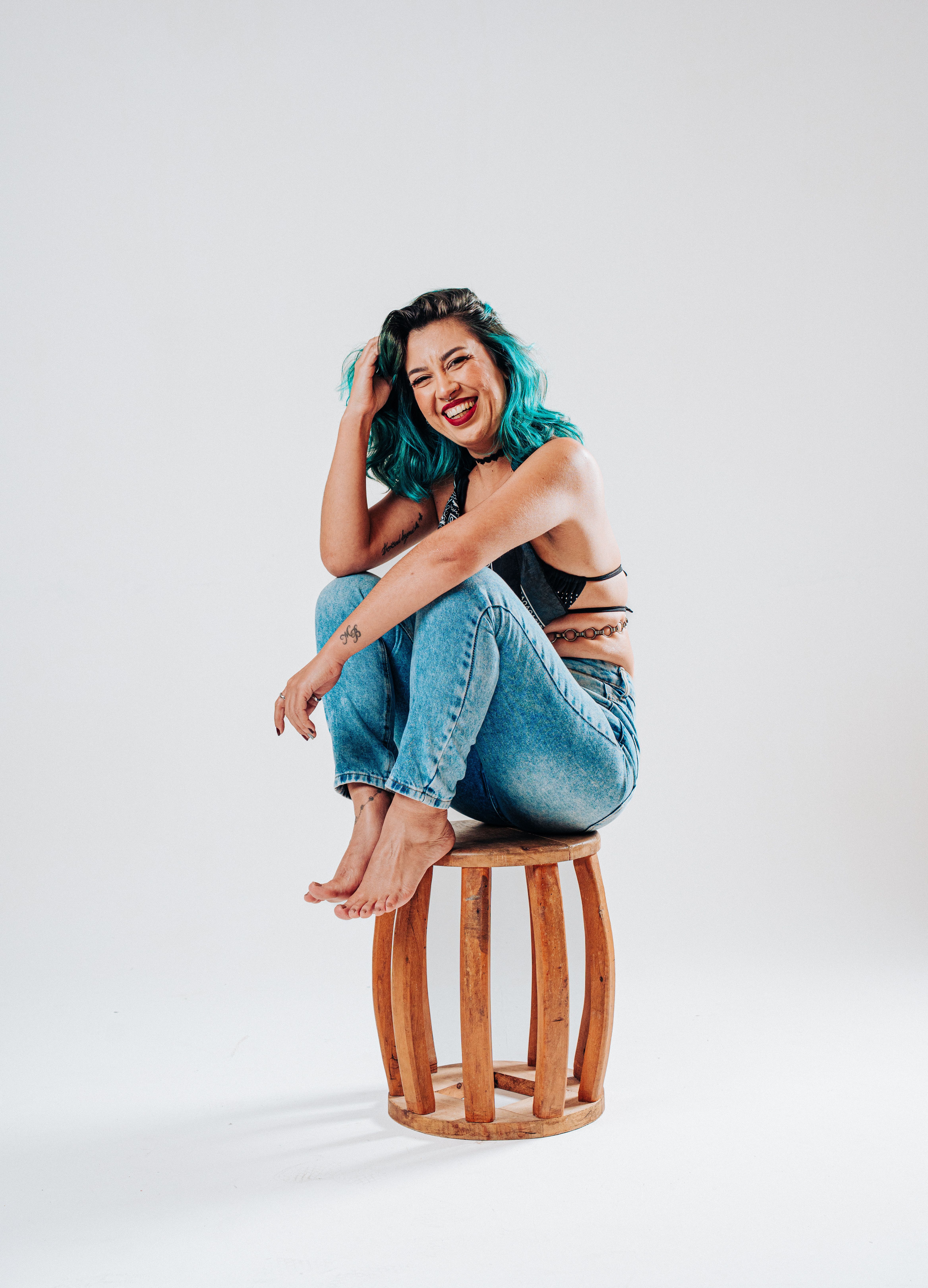 Stylish Woman with Blue Hair Sitting on a Stool · Free Stock Photo