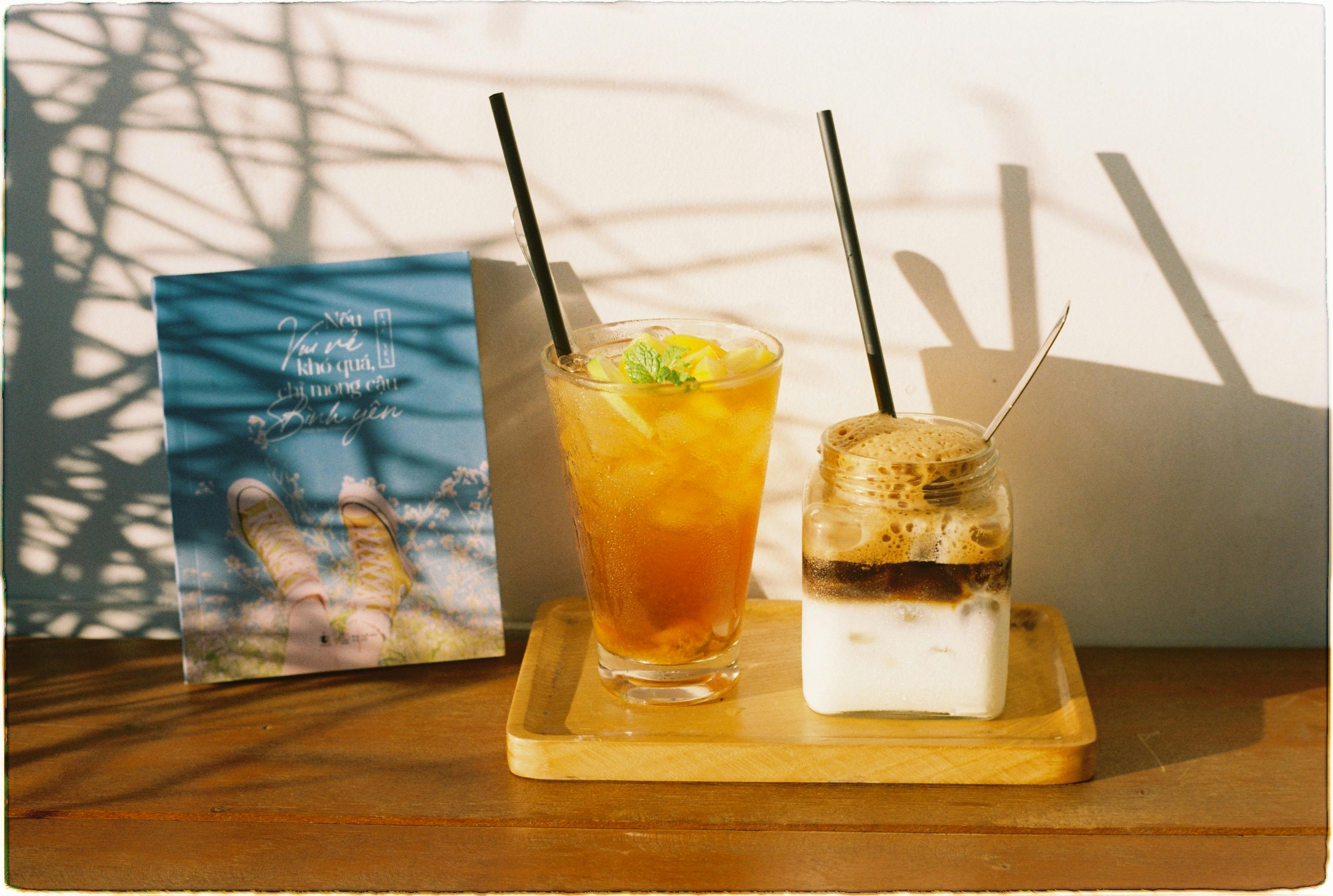 Close-up of iced tea and coffee with creative shadows, perfect for summer vibes.
