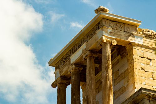 Free Close-up of an ancient Greek temple with Doric columns against a blue sky. Stock Photo