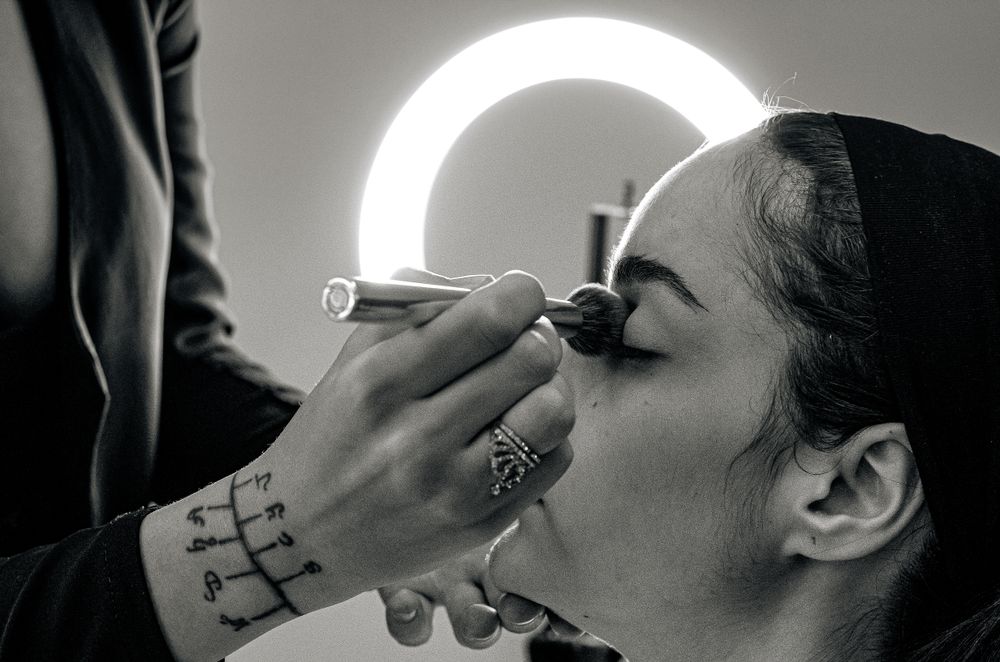 An artist working on a model under studio lighting