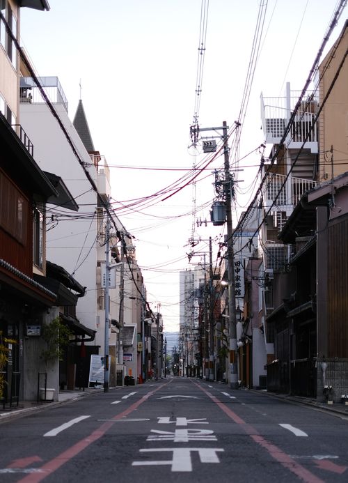 Free Deserted city street with urban architecture and power lines at dusk in Japan. Stock Photo