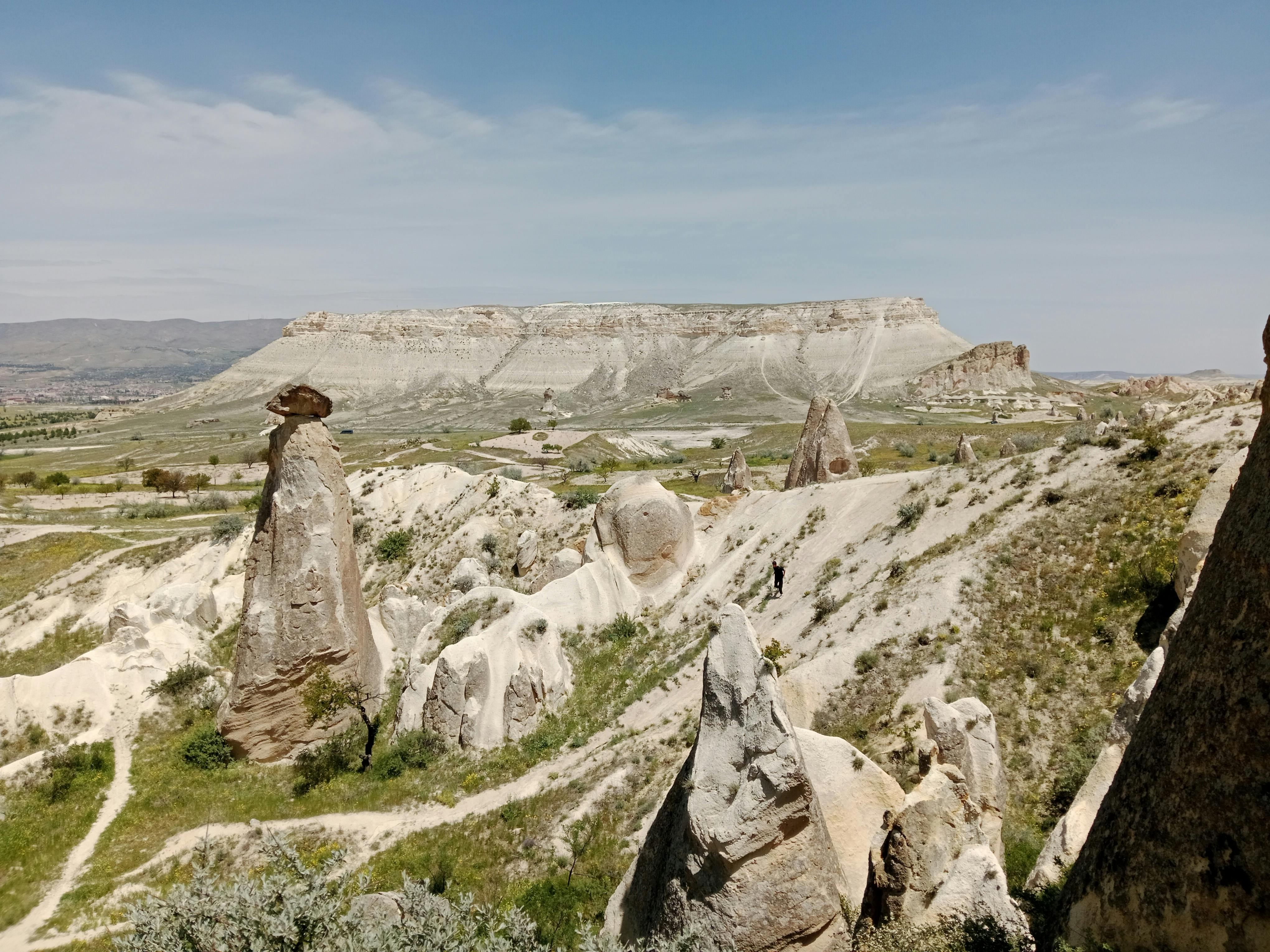 Entrance to the Valley of the Kings under blazing sun with visitors walking towards it