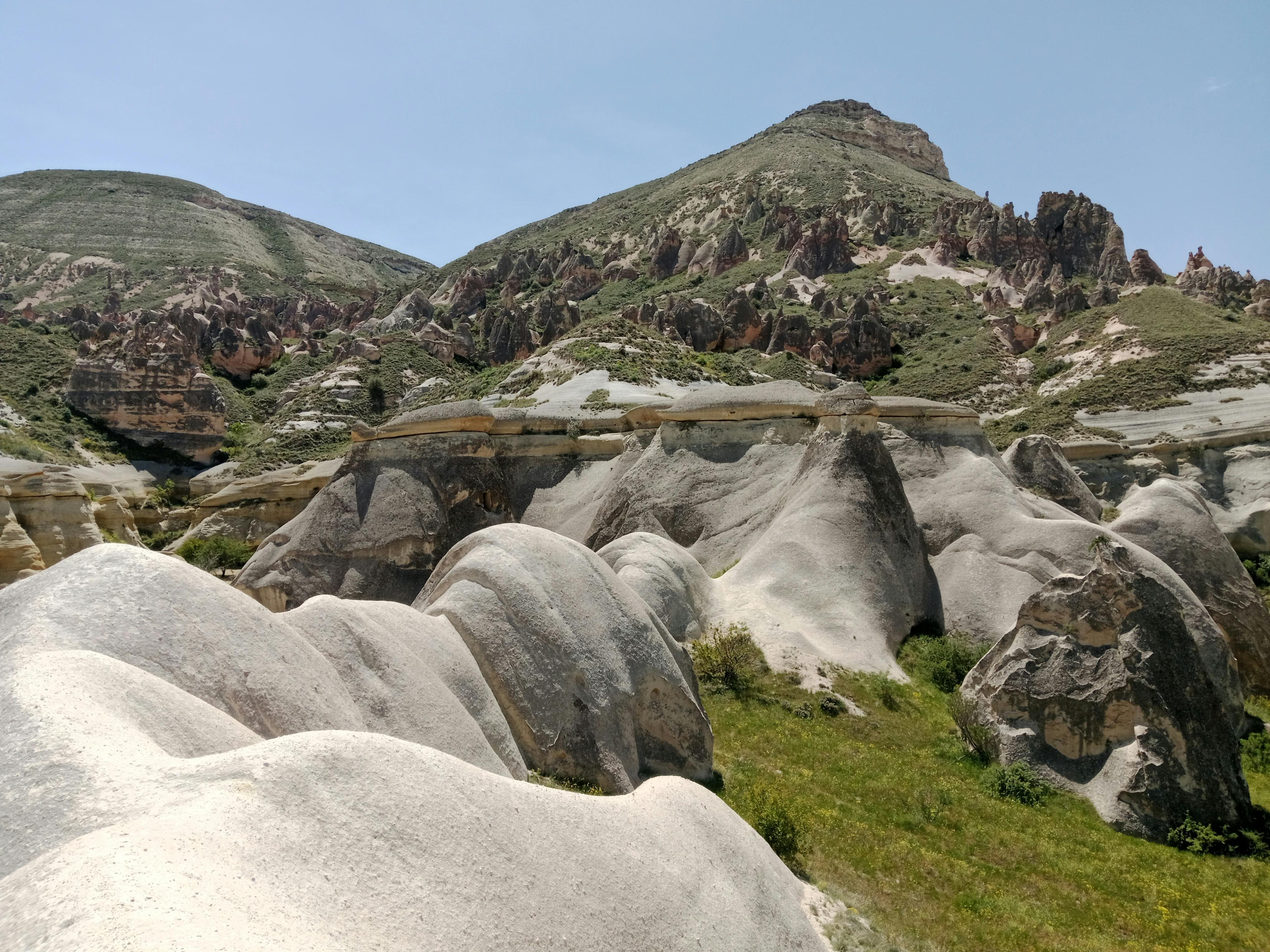 Majestic and unique rock formations in Cappadocia under a clear blue sky.