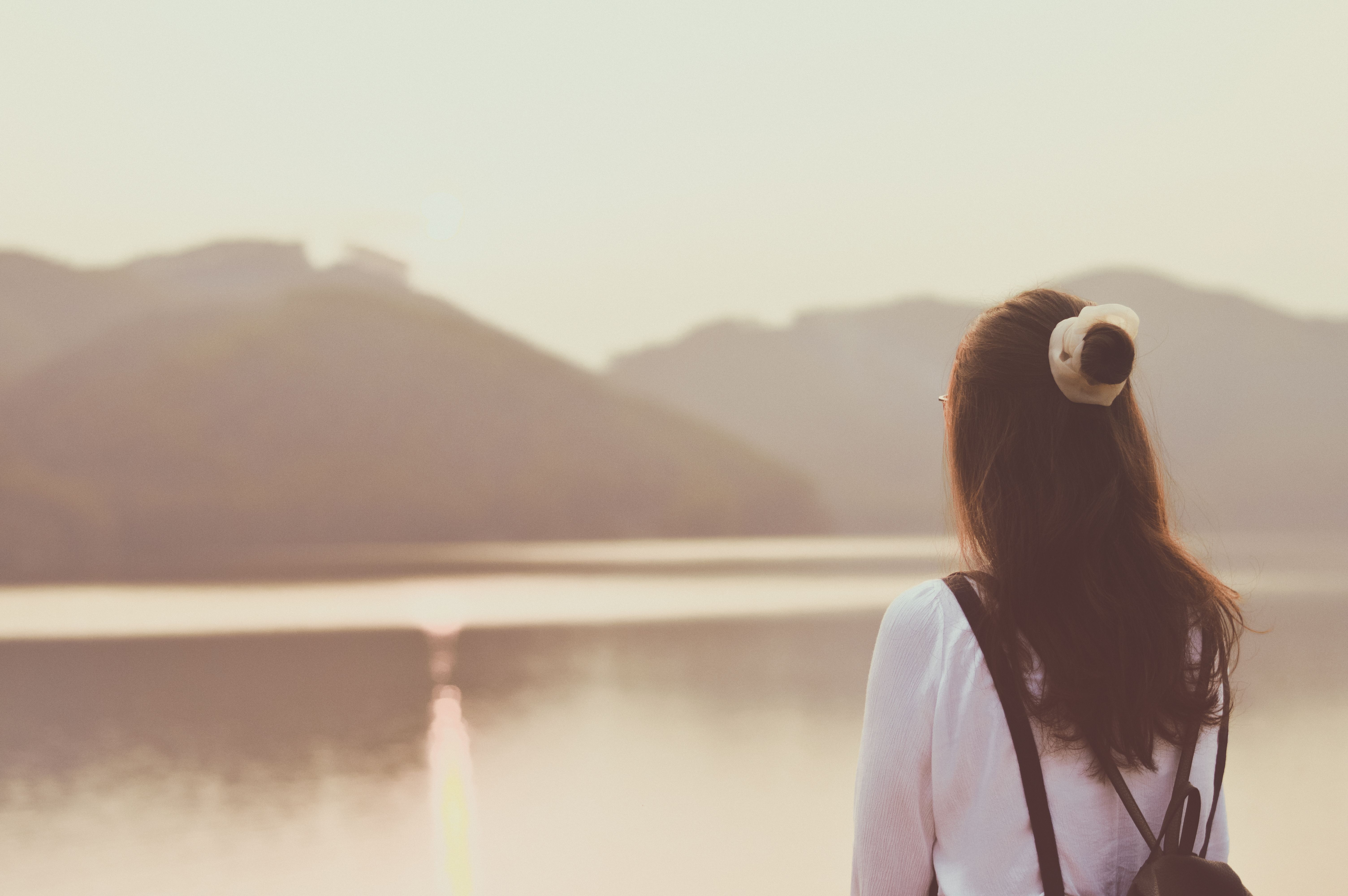 Woman Enjoying Tranquil Lakeside View at Sunset · Free Stock Photo