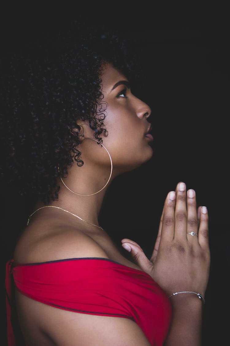 Woman In Red Top Praying