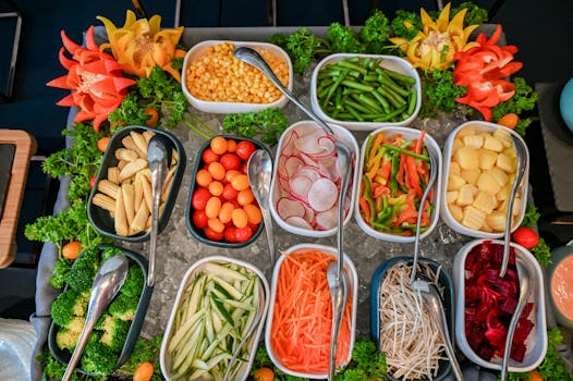An assortment of fresh vegetables displayed in a colorful salad bar arrangement.
