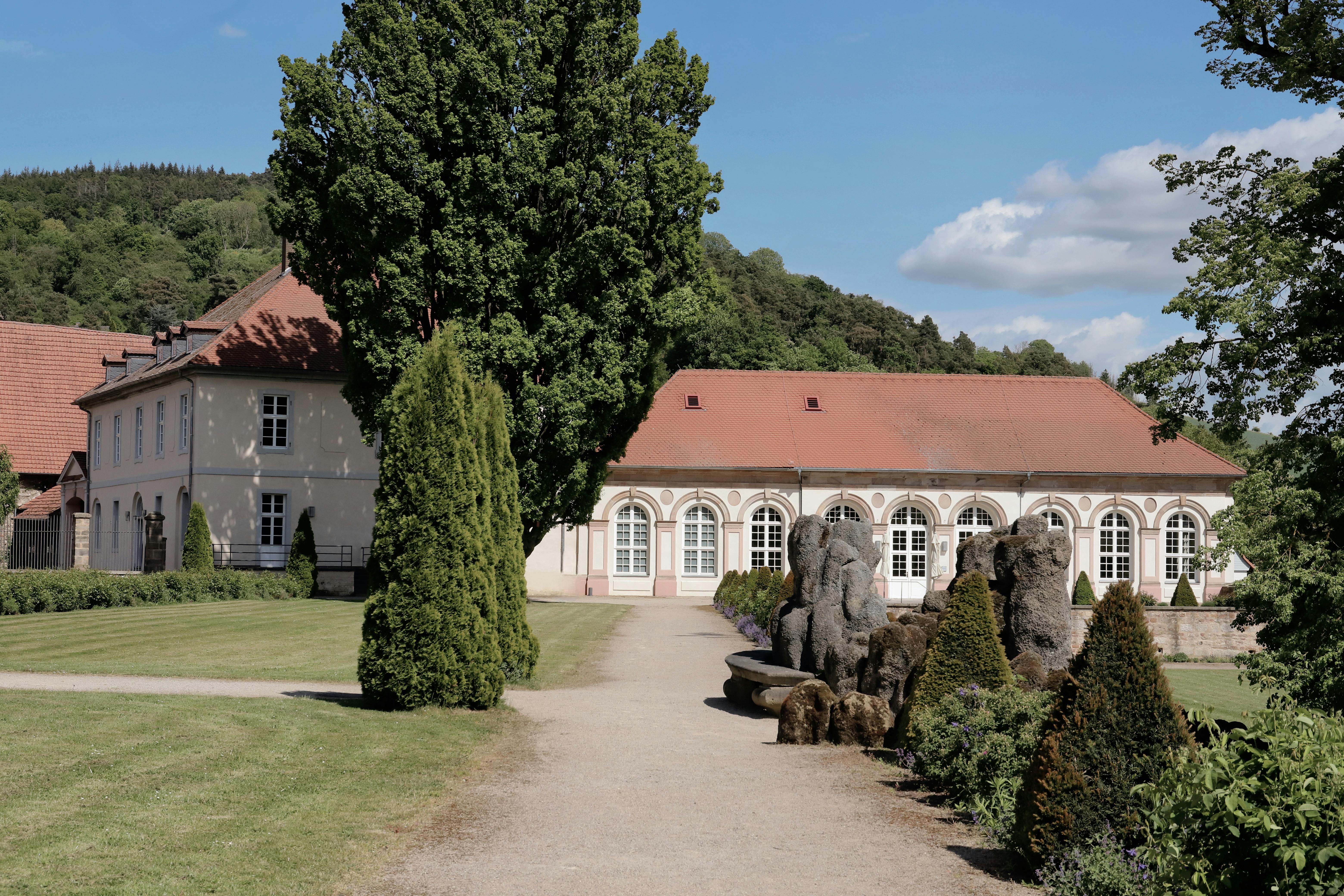 Charming historic estate with manicured gardens in Morschen, Hesse, captured on a sunny day.