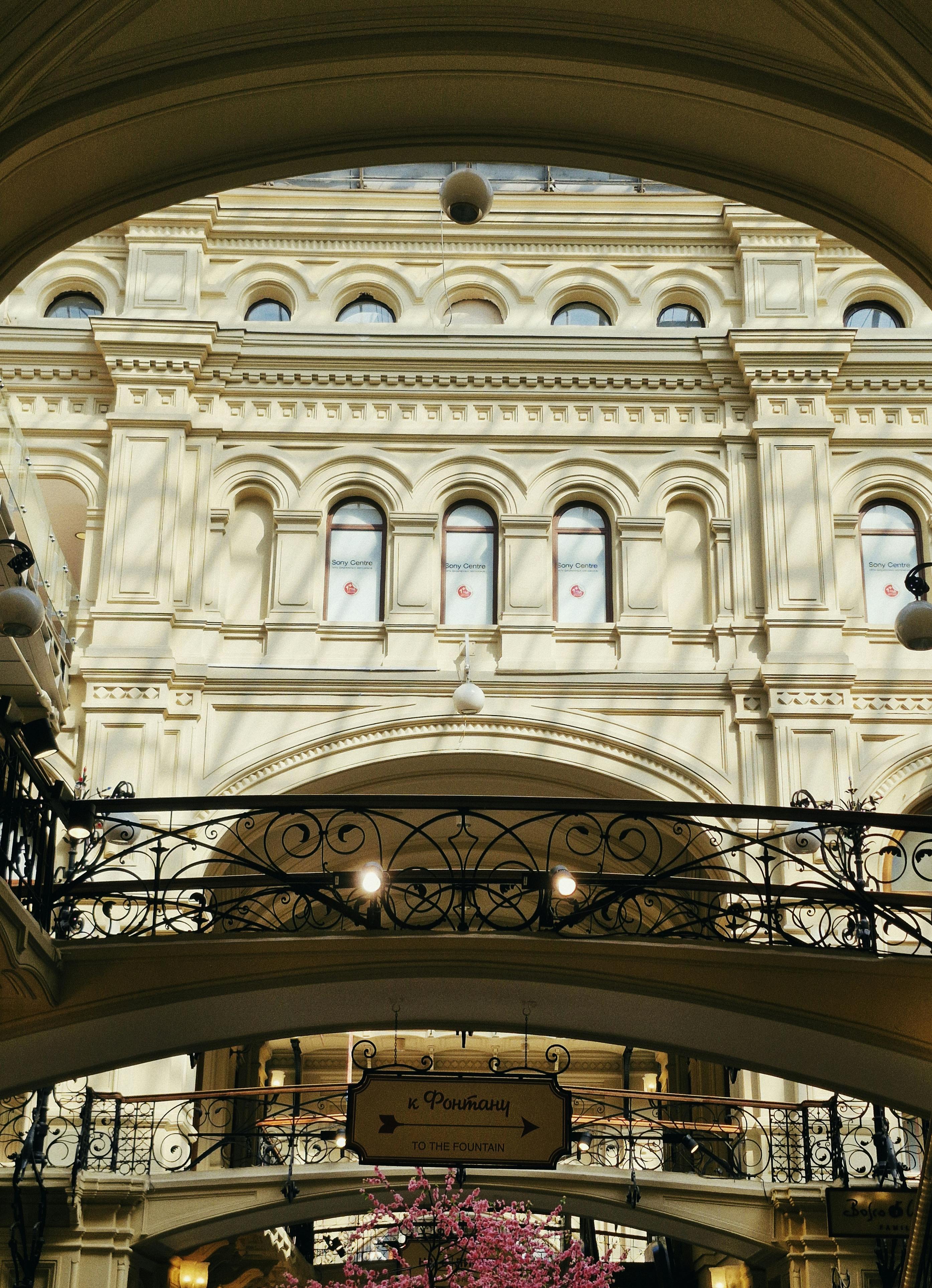 Free Beautiful European mall interior with detailed arches and decorative railings, creating a classic and elegant ambiance. Stock Photo