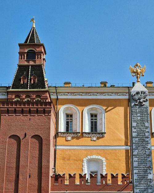 Free Detailed view of the Kremlin wall and a monument in Moscow under clear blue sky. Stock Photo