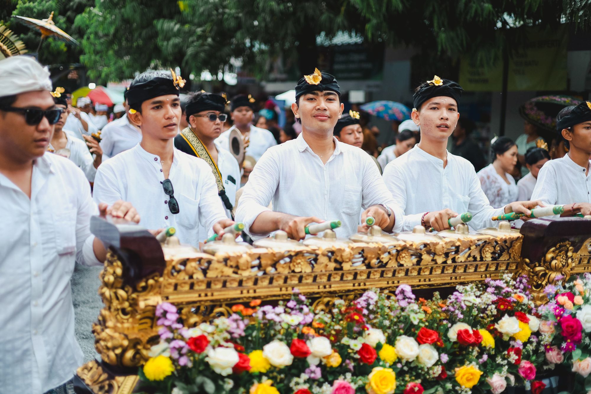 Balinese musicians performing gamelan together during a traditional ceremony