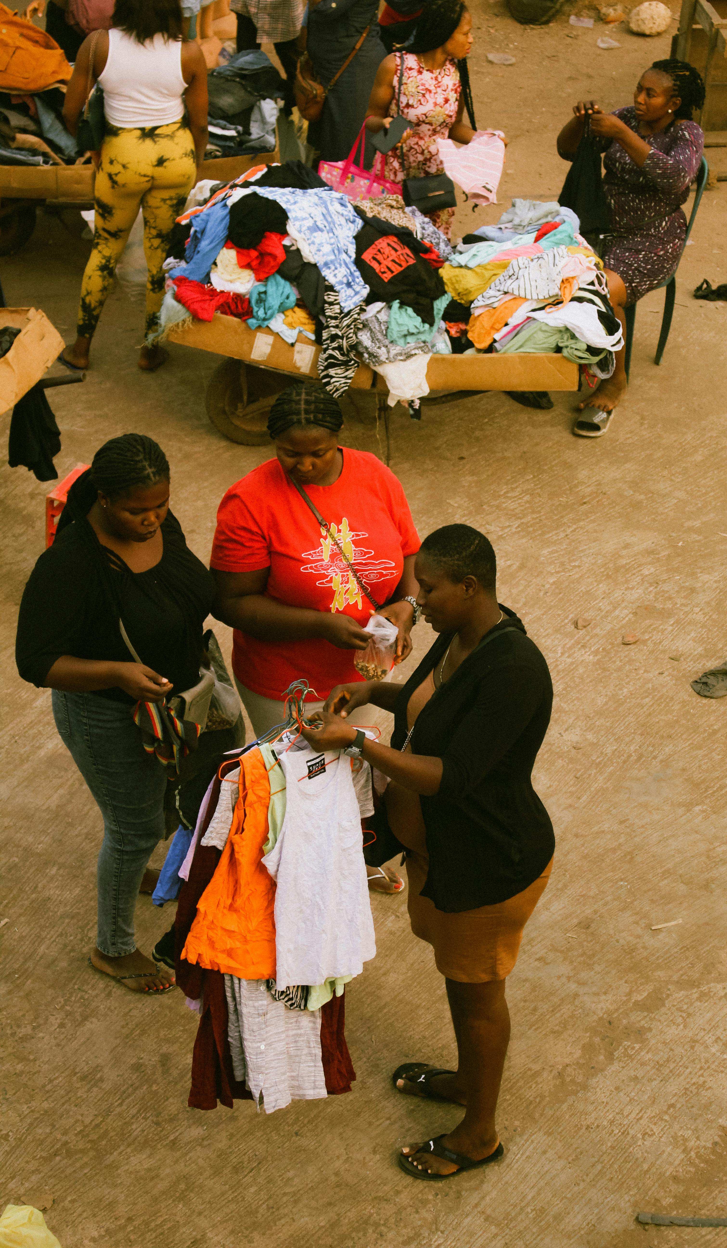 Vibrant market day in Enugu, Nigeria featuring buyers and sellers exchanging goods.