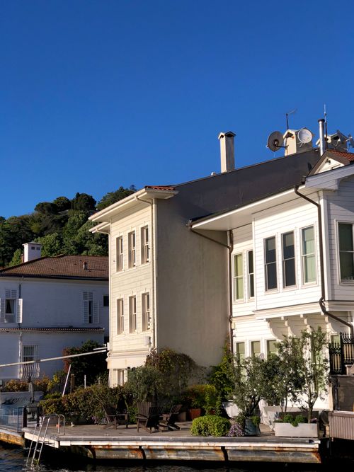 Free Elegant waterfront house with terrace by the water on a sunny day. Stock Photo