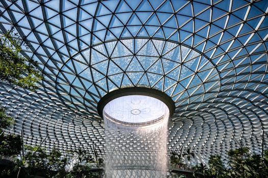 A stunning perspective of the Jewel Changi Airport's iconic indoor waterfall in Singapore.