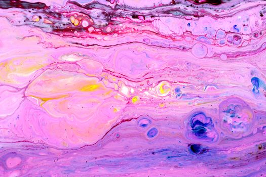 Vibrant and colorful abstract liquid paint art with swirling patterns in pink and purple tones.