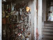 Wires, tools, and gadgets clutter the wall of a mechanic's workshop showcasing an industrial vibe.