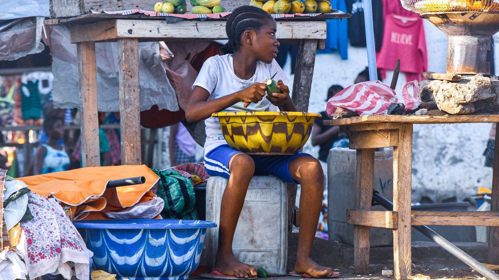 Young girl preparing fruits at monrovia market, Liberia