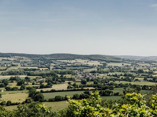 Free Picturesque view of the rolling countryside in France, showcasing lush greenery in spring. Stock Photo