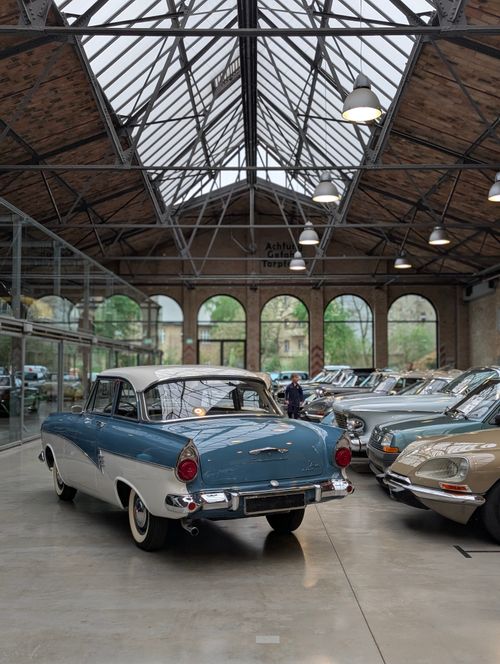 Free Explore a stunning collection of vintage cars in a historic Berlin showroom with glass ceilings. Stock Photo