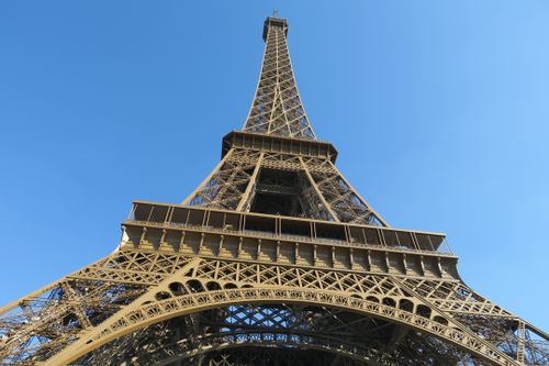 Free Close-up of the Eiffel Tower against a clear blue sky in Paris, France. Stock Photo