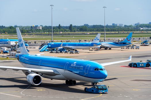 KLM aircraft preparing for takeoff at Amsterdam Airport Schiphol on a clear day.