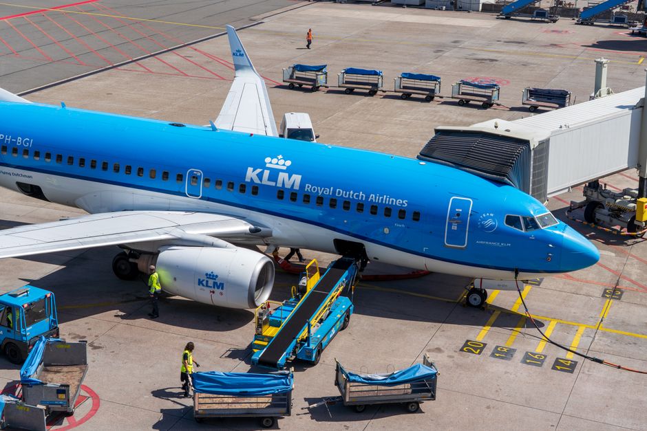 Traveler checking in luggage at a Sky Airline counter in a Chilean airport