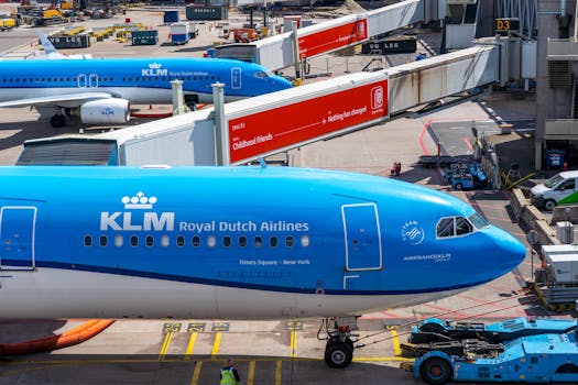 KLM Royal Dutch Airlines planes at airport gate, bustling aircraft activity.