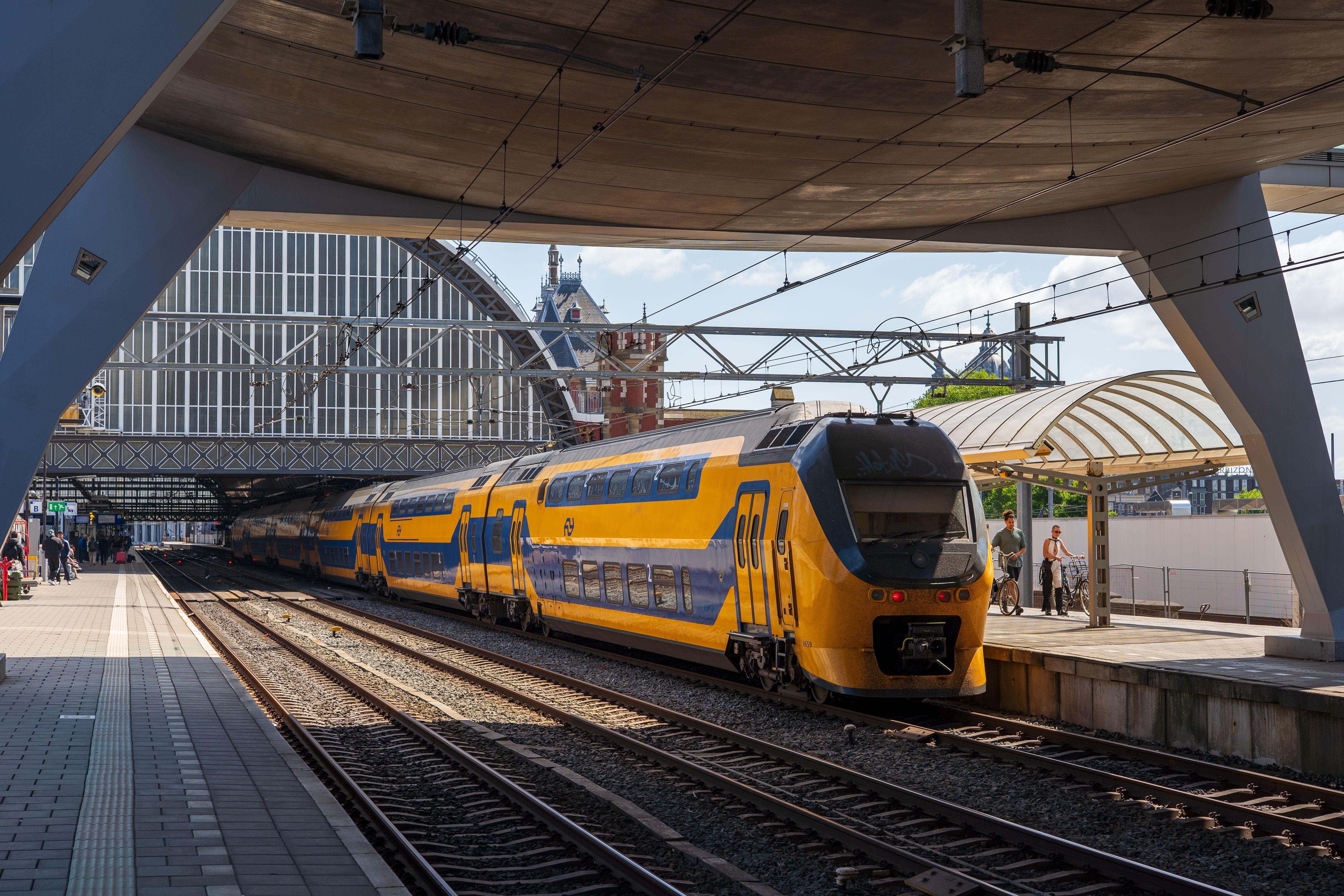 Blue and yellow Dutch intercity train arriving at Alkmaar station