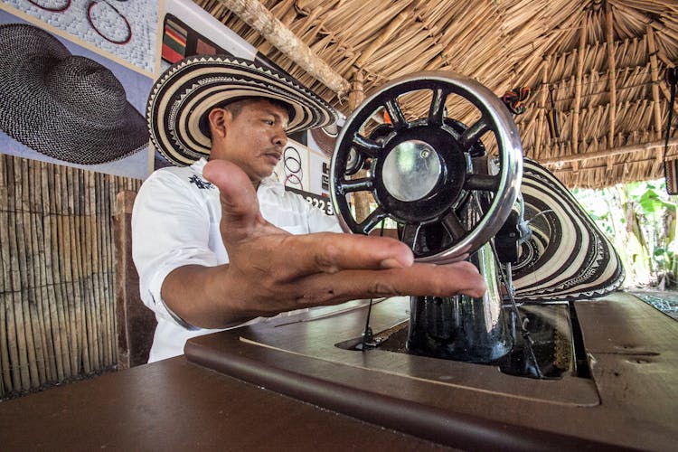 Man Sitting In Front Of Sewing Machine